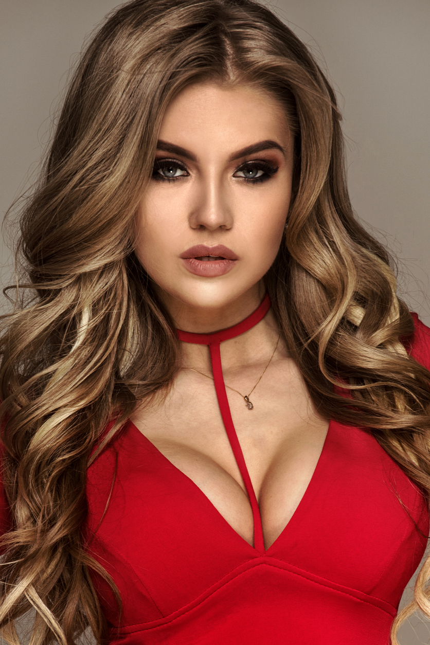 attractive woman in red dress with large breasts